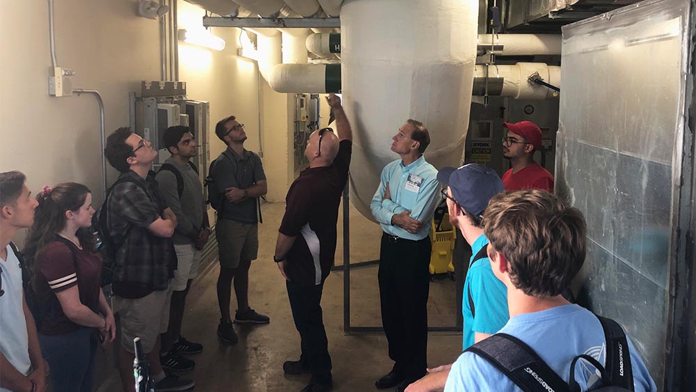 a large group of students on a technical visit to a utility and energy site