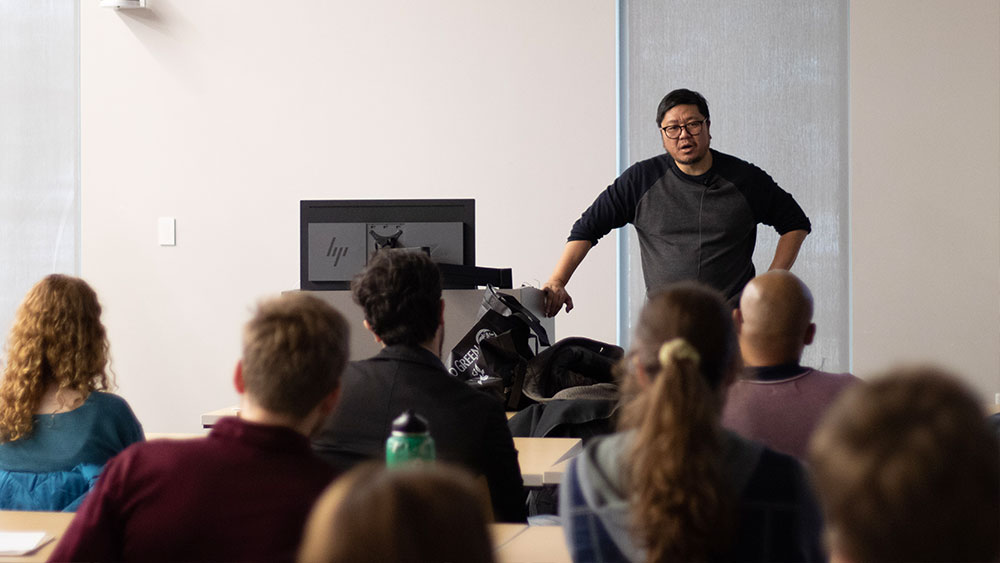 A speaker presents to students