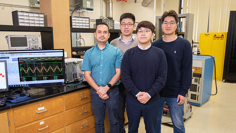 Computer engineering student researchers posing for photo in a lab.