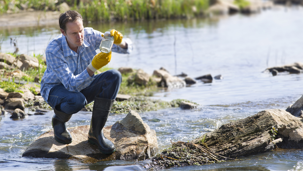 Man testing quality of natural water