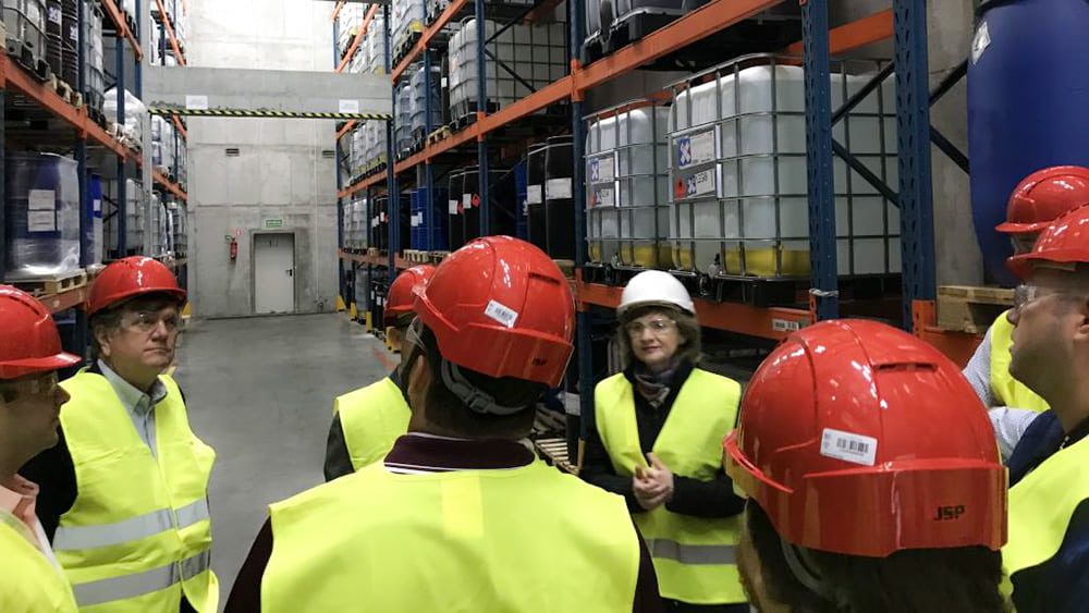 People with hardhats and goggles inside a facility