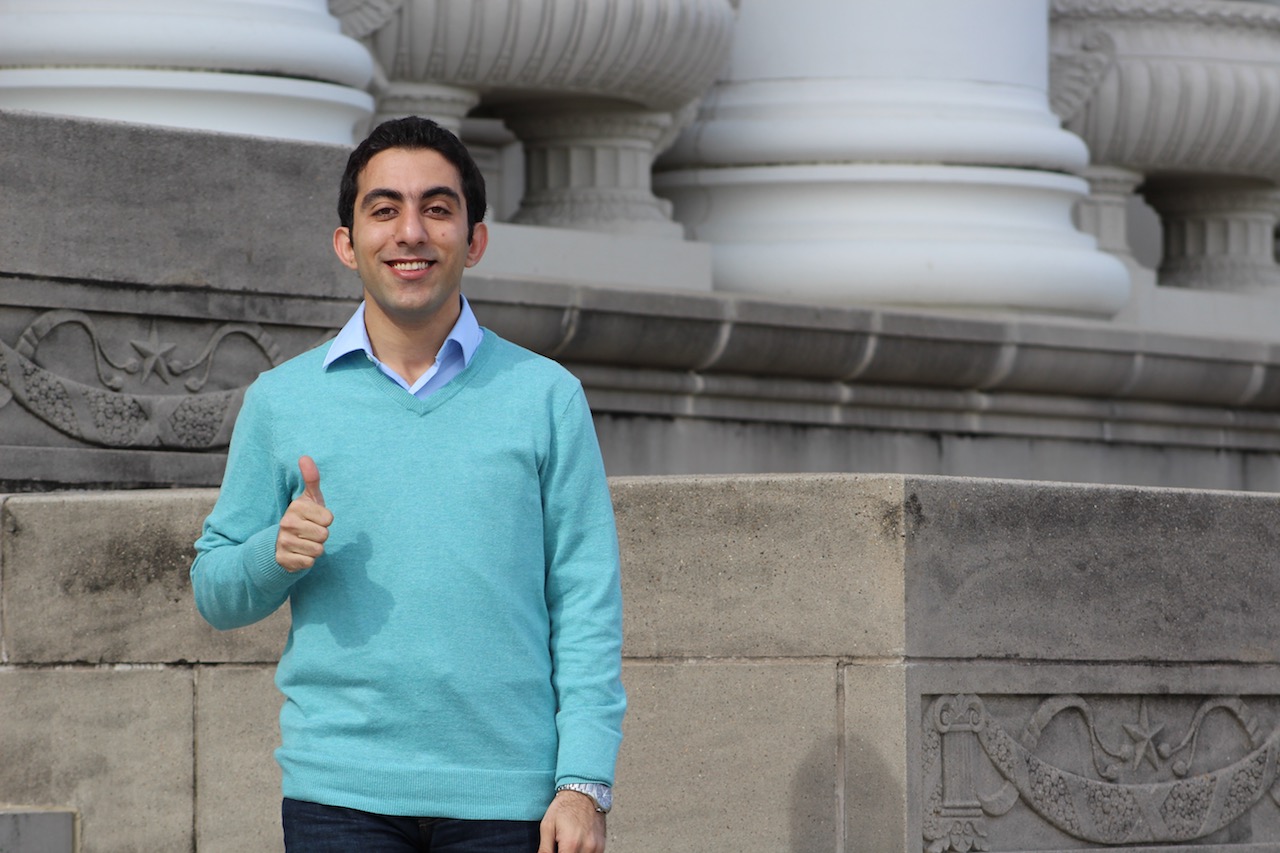 Dehghanian standing in front of building giving thumbs up.