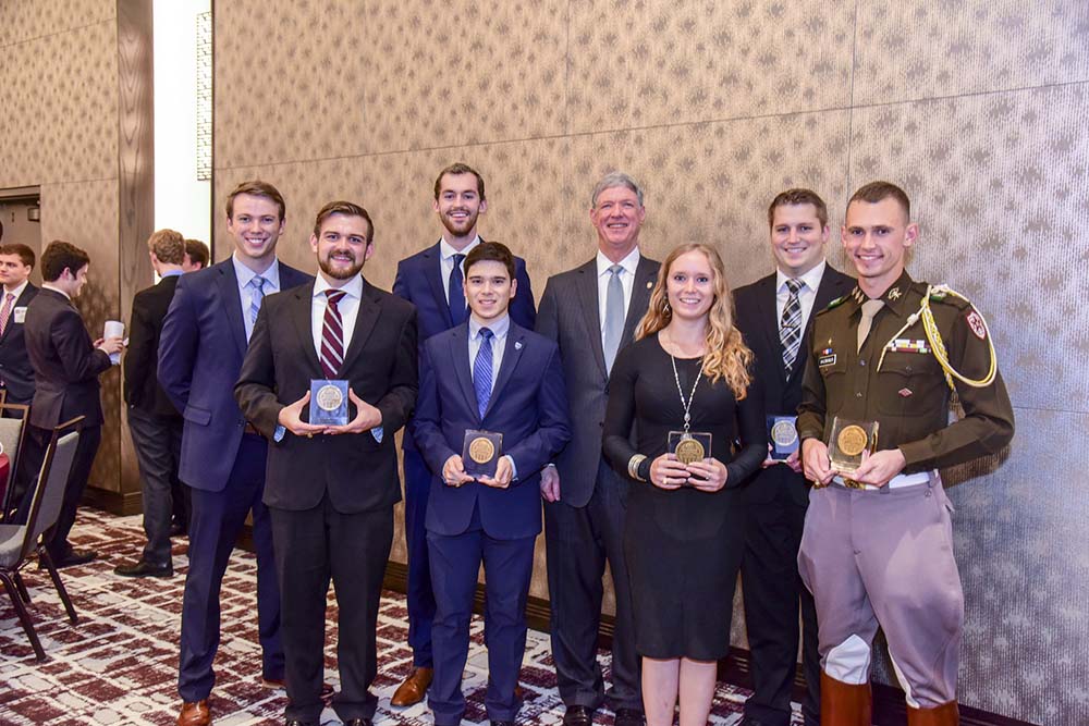 Craig Brown ’75 and seven Outstanding Seniors Award seniors at banquet.