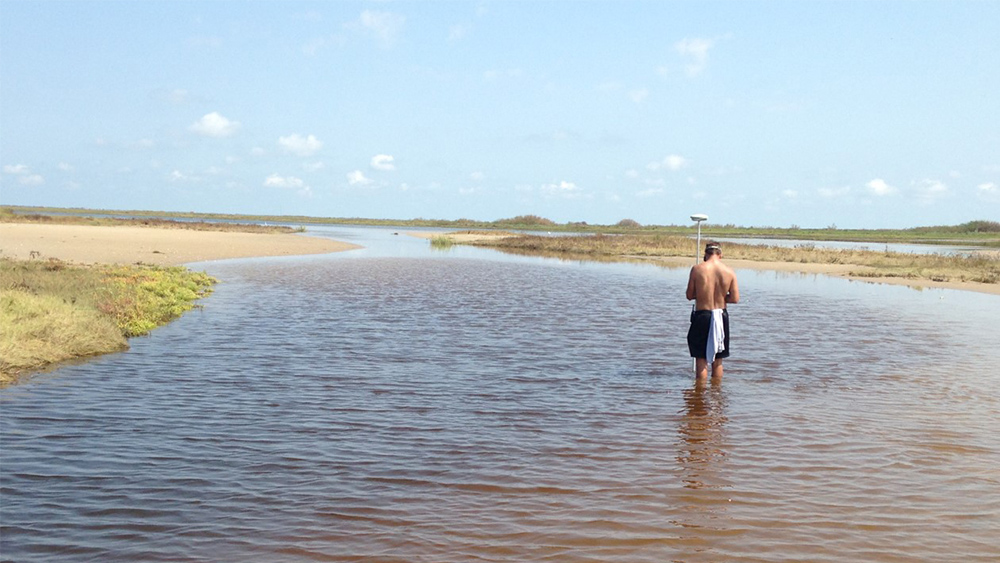 Mick Prouse collects data along the shoreline in Galveston, Texas.