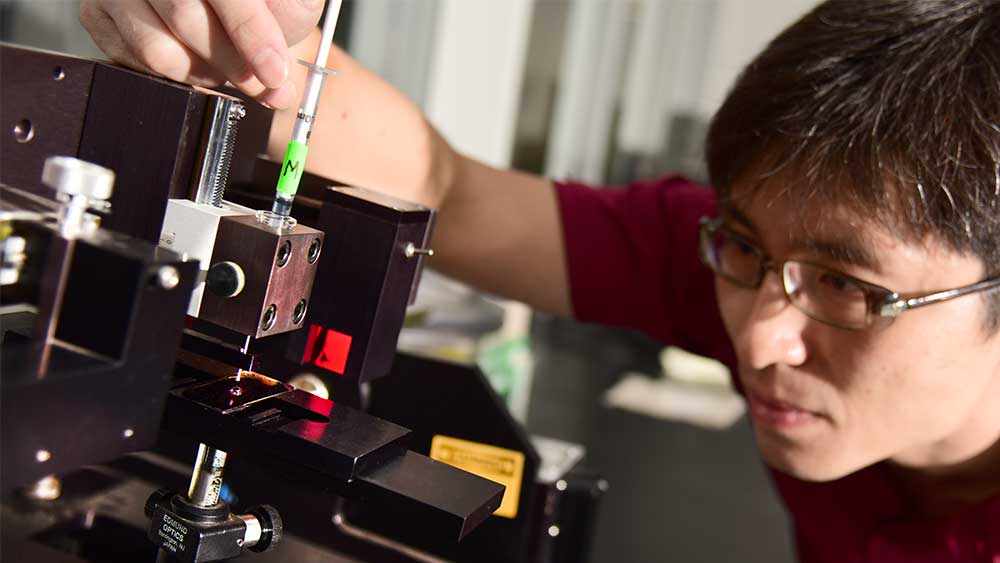 Student in a lab working with machinery