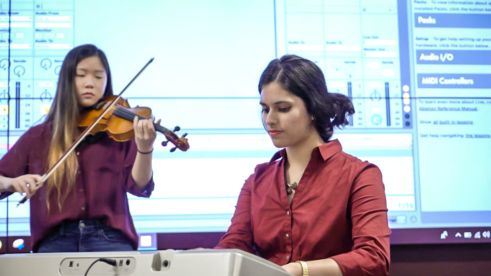 General engineering student Ritika Bhattacharjee playing piano at Binomial Rhapsody performance