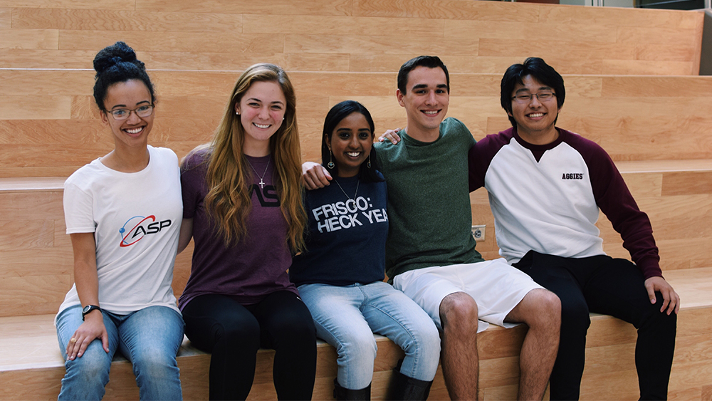 Five students sitting on the stairs in the Zachry building