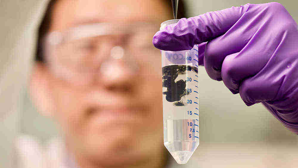 Xiaofei Zhao prepares a Ti3C2 MXene dispersion in sodium L-ascorbate solution at Texas A&M University.  