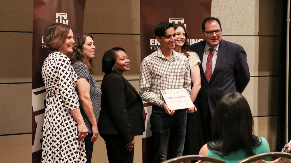 Jorge Hernandez receives his certificate of completion for the summer bridge program