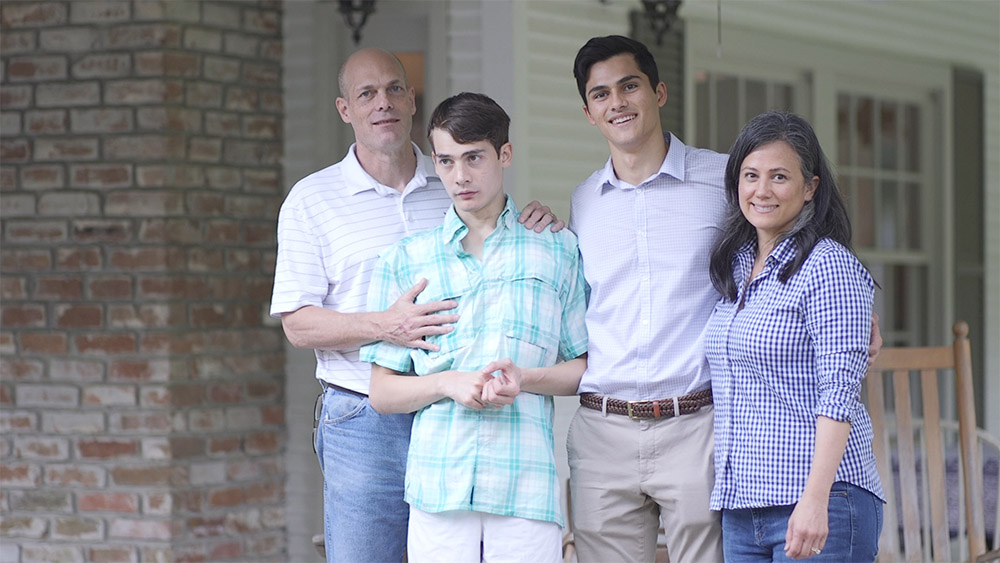 The Bliss family stands on their front porch