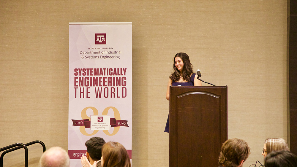 Maria Cabrera Lehmann gives a speech on a stage. 