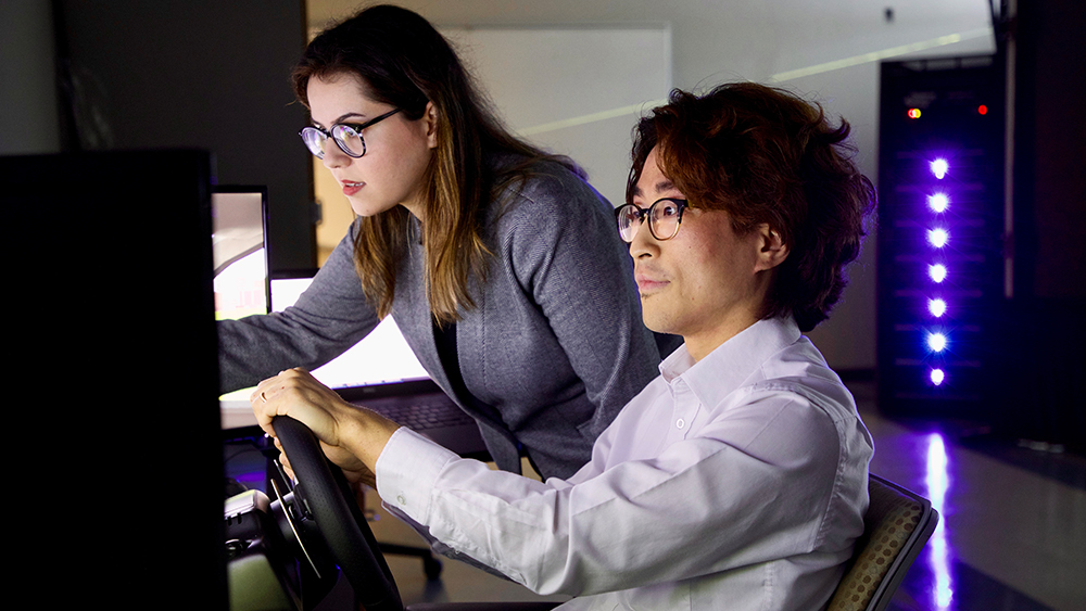 Dr. Maryam Zahabi points to a computer screen. 