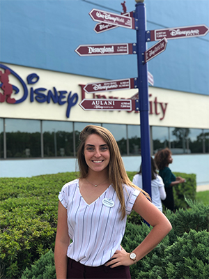 Stephanie Cruz stands in front of a Disney office building. 