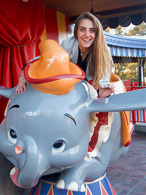 Stephanie Cruz sits on the elephant dumbo in a Walt Disney World park. 