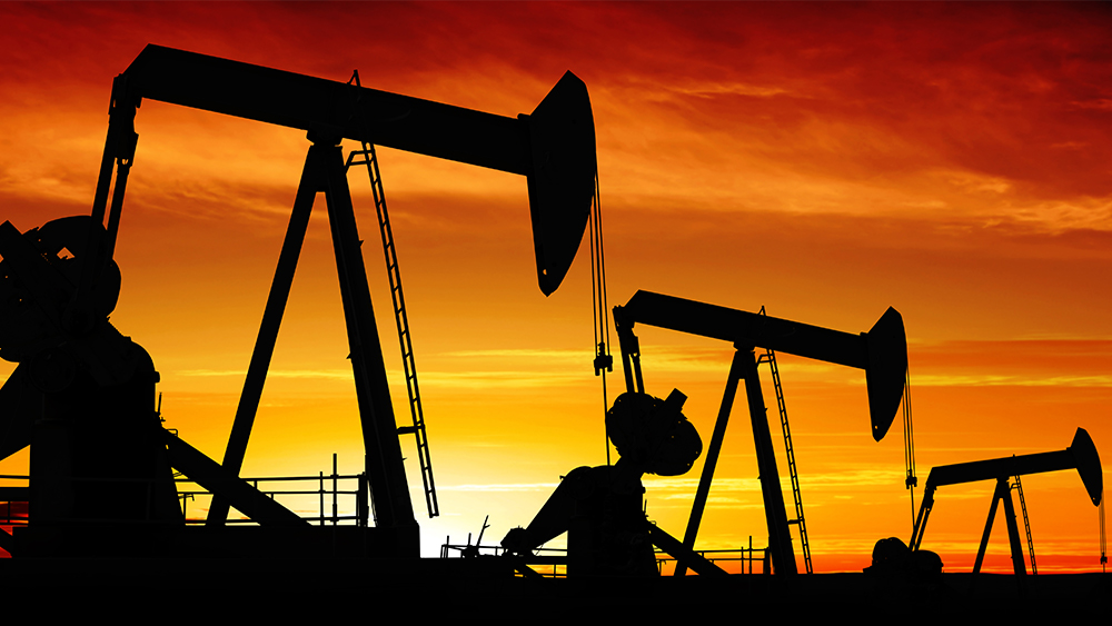 row of pumpjacks at sunset