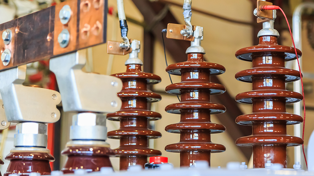 A picture of electric bushings on a power transformer.