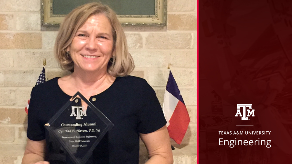 Cindy Haven holding her Outstanding Alumni Award plaque