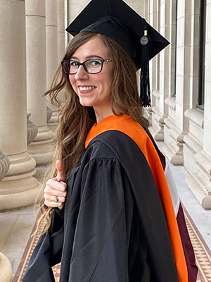 Gibbens smiles and poses for graduation pictures.