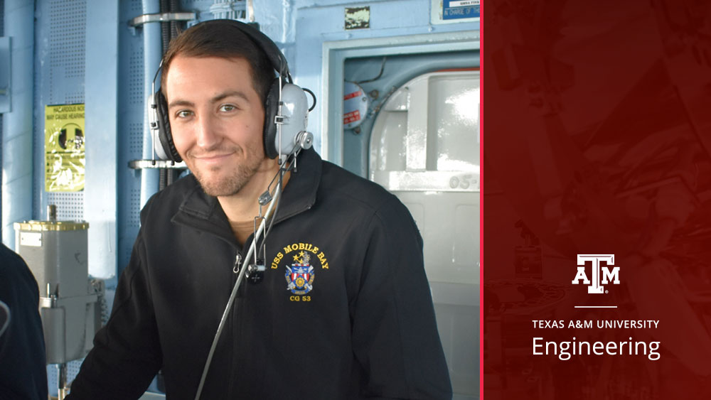 Graduate student Alex Rubin stands inside a naval submarine wearing a headset. 