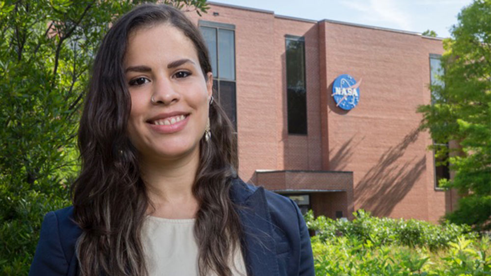 Santini De León smiling outside of a NASA building.