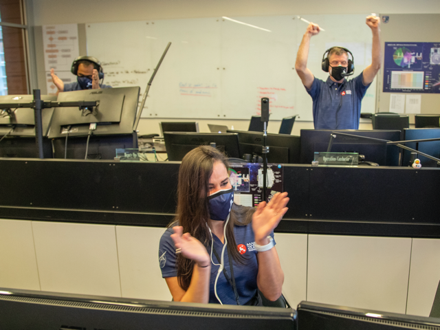 Santini De León celebrating with coworkers after the Perseverance rover successfully landed on Mars.