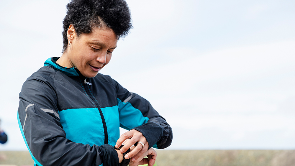 Woman looking into a smartwatch.