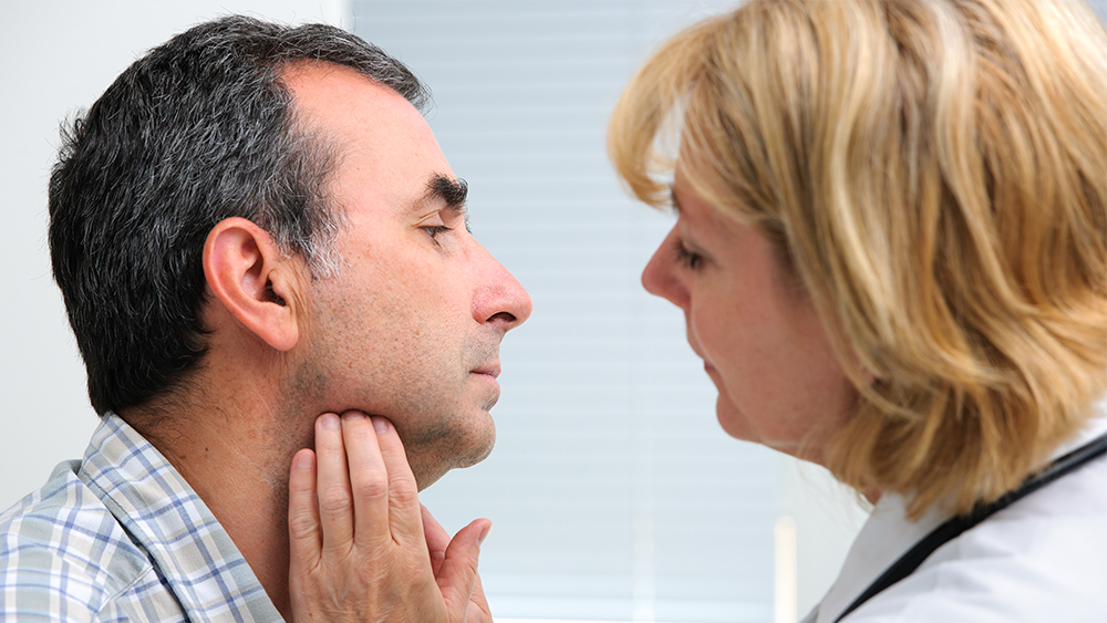 Doctor examining a patient's mouth.