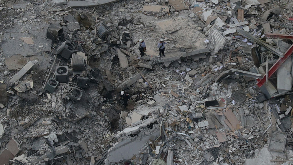 Search and rescue workers searching through the rubble of the Champlain Towers South Condo building.