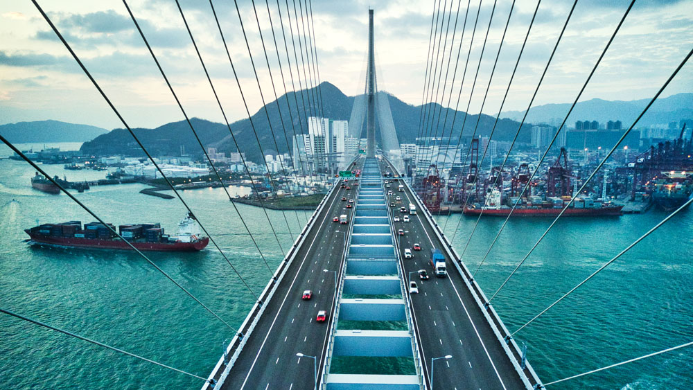 A bridge leading into a coastal city.