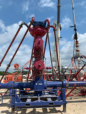 tall structures made of metal chambers and valves with several pipes and hoses attached