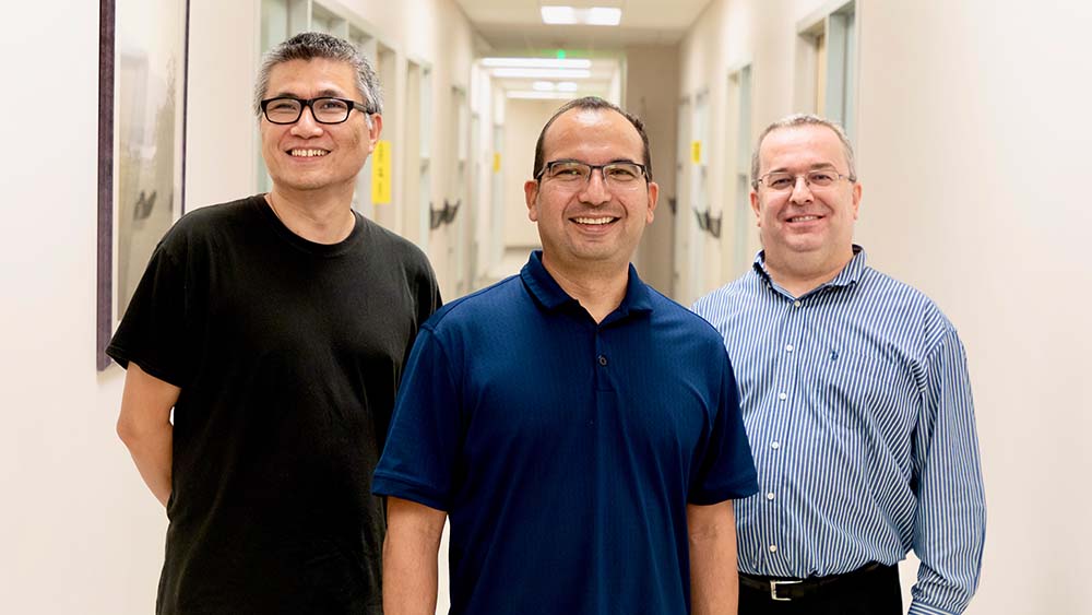 Drs. Xiaoning Qian, Raymundo Arróyave and Ibrahim Karaman stand in a hallway