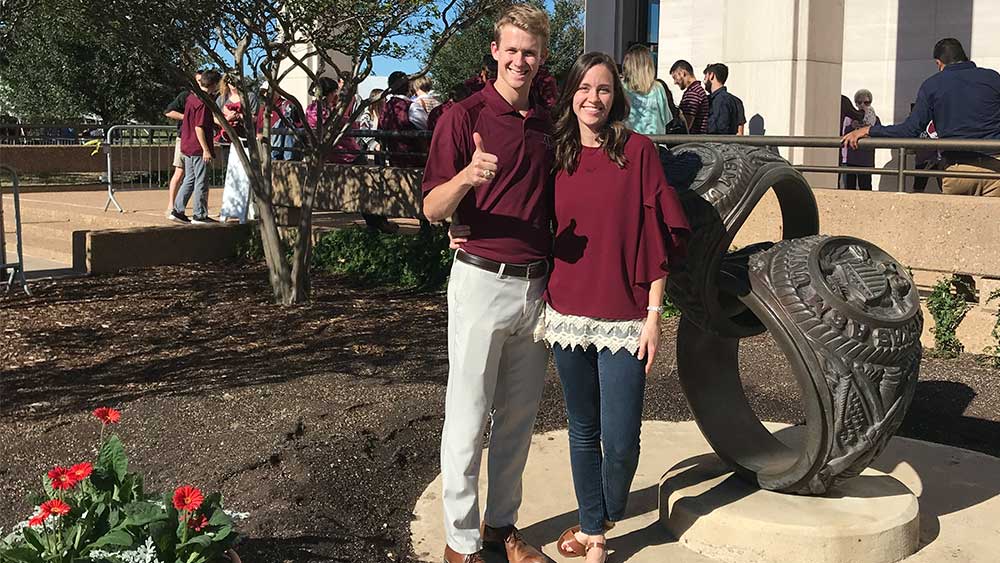 Man thumbs up with smiling woman