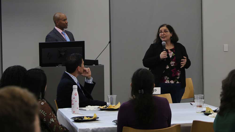 A man at the podium, and a woman speaking into a microphone.