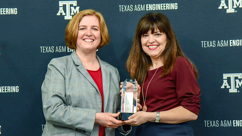 Dr. Katherine Banks presenting Aleida Rios with an award 