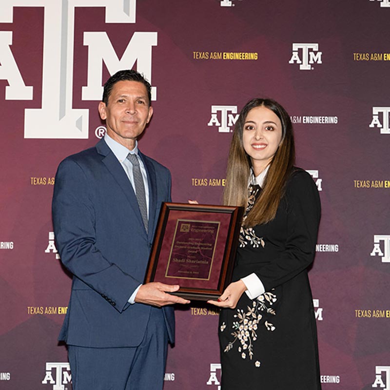 Shadi Shariatnia shakes Dr. Hurtado's hand while accepting her award