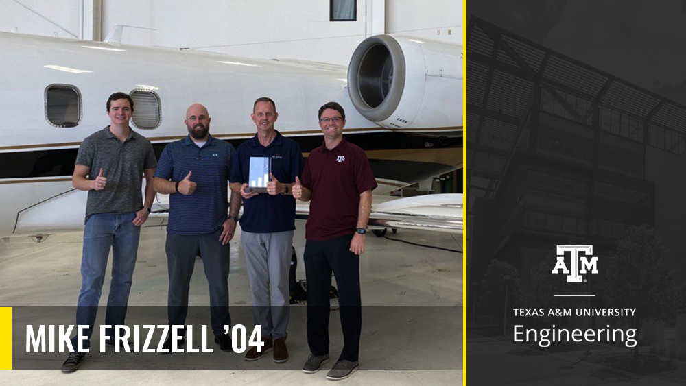 Four Aggie engineers employed at Albers Aero stand in front of a small aircraft with their Aggie 100 plaque.