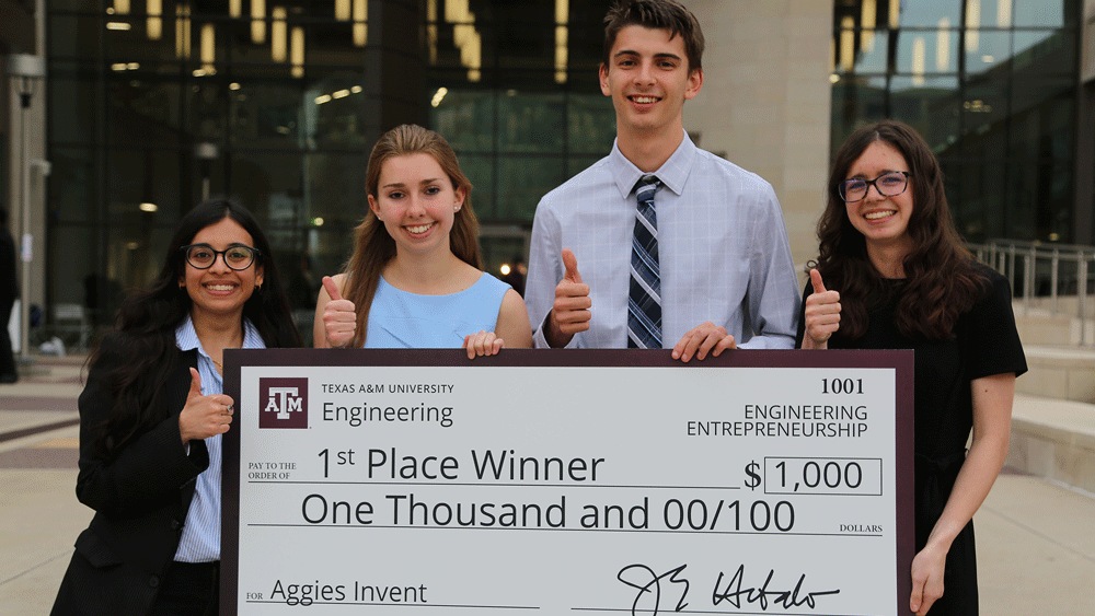 Group posing with giant check.