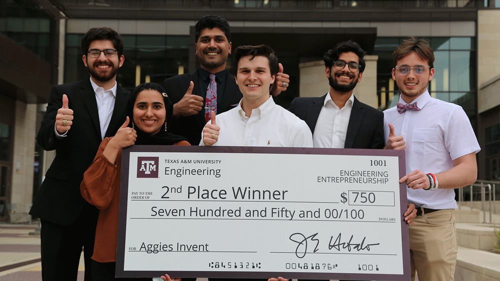 Group posing with a big check.