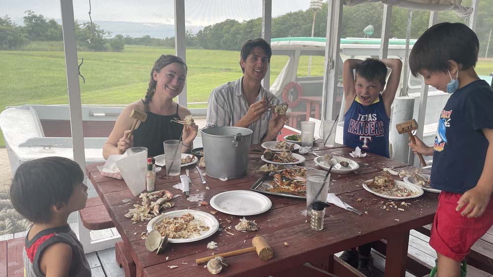 Dr. Christie Bergerson sits with her husband and three sons at the dinner table.