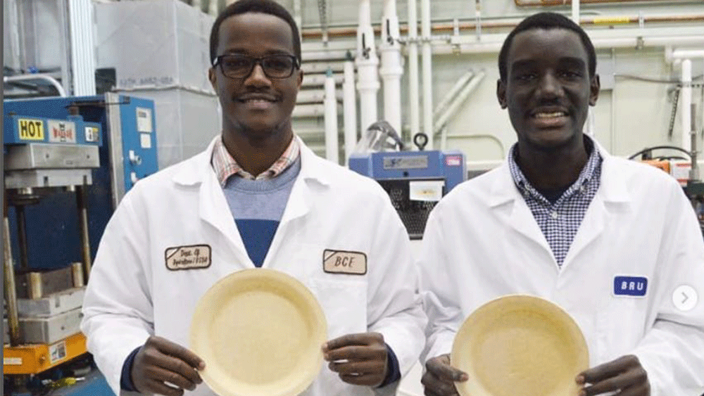 Two men holding pasta plates