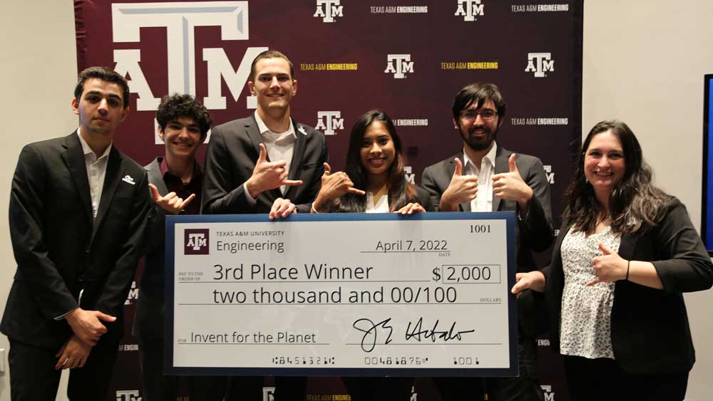 Group of students holding up a big check for 3rd place.