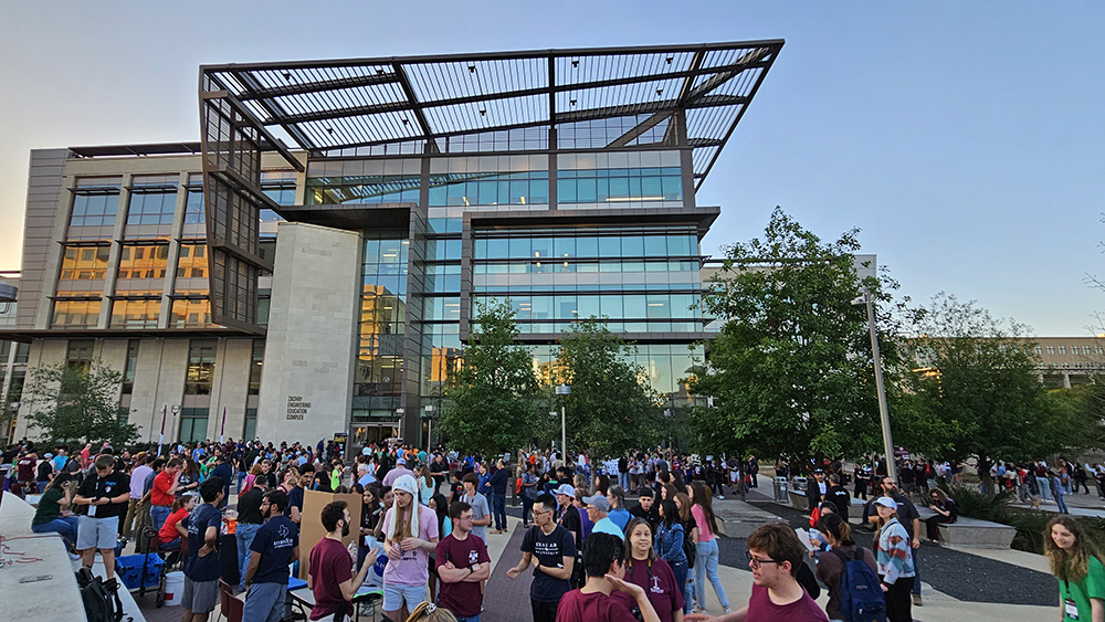 Hundreds of people interact with exhibitors outside the Zachry Engineering Education Complex.