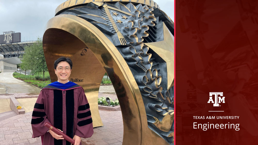 Dr. Taekwang Ha stands outside by the Aggie Ring statue on campus in his doctoral robes holding his degree. A stadium with the Texas A&M logo is visible in the background.