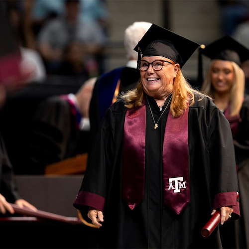 Denise Meyer wearing Texas A&amp;M graduation cap and gown.