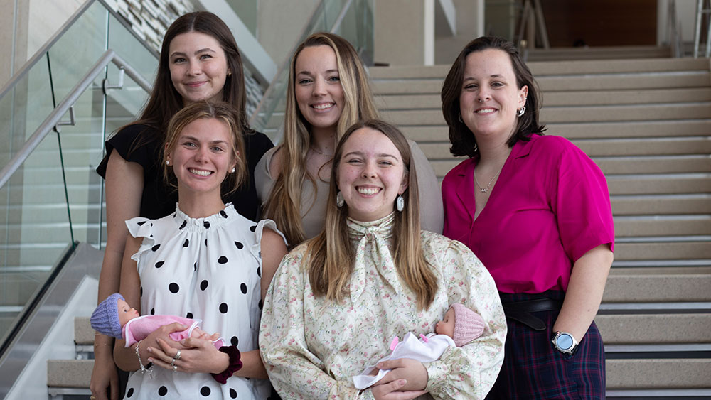 Team 11 is shown starting from the top row: Amelia Flug, Hannah Bludau, Haley Phelan. Bottom row: Reagan Isbell, Naomi Brady.