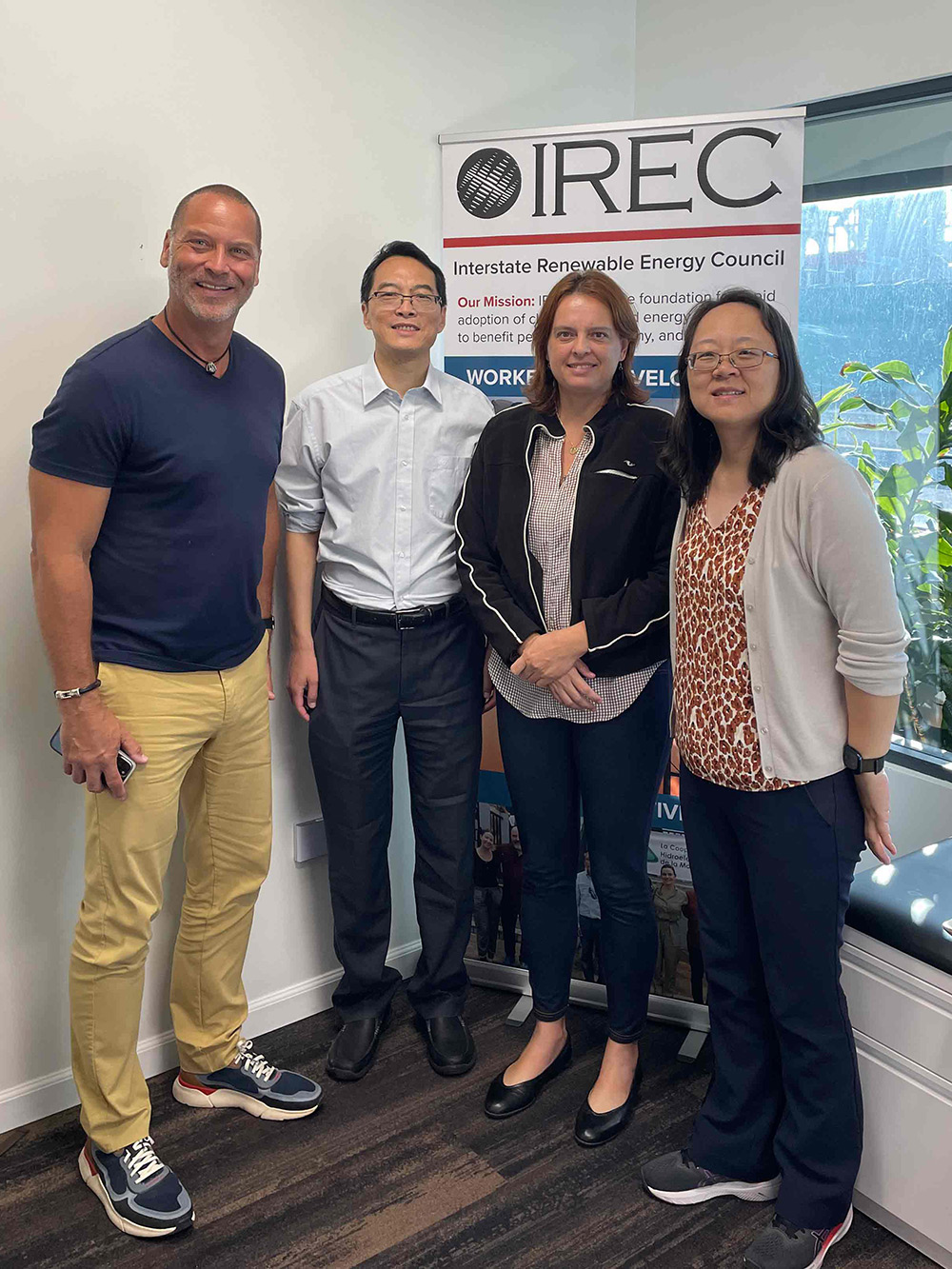 Four research team members posing in front of a backdrop.