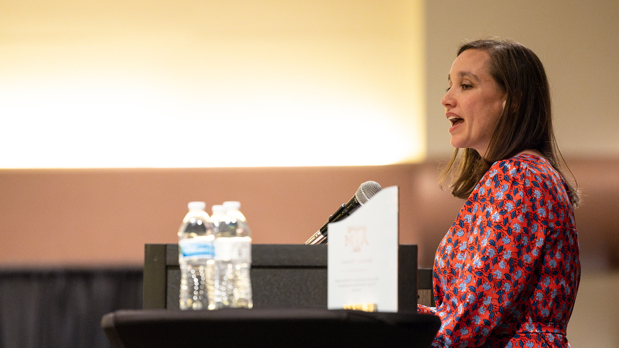 A woman speaking at a podium.