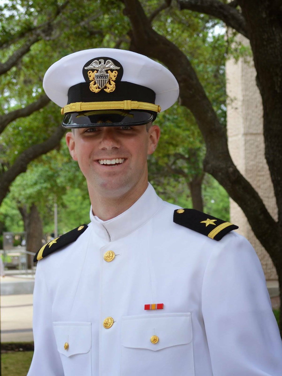 A man in military uniform smiling.