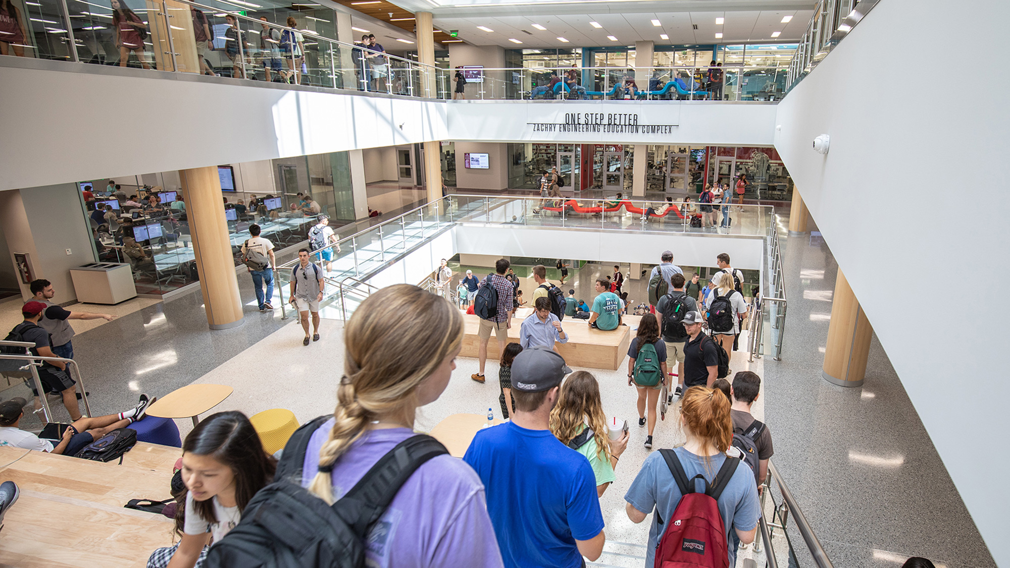 Students walking up and down the stairs in the Zachry Engineering Education Complex.