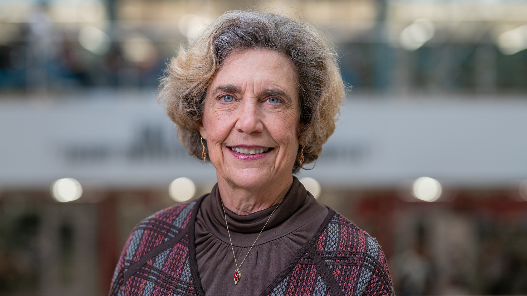 A woman dressed in professional clothing posing for a headshot.